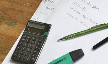 calculator and paper figuring out flooring budget