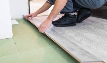 KB Construction team installing new laminate flooring