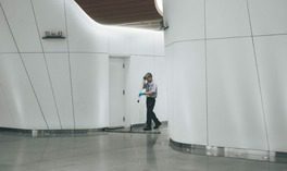 employee sweeping hallway